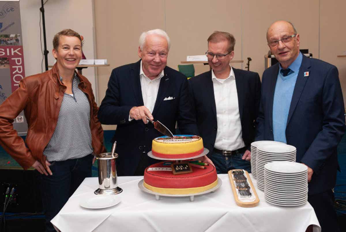 Nicole Wind, Claus Brüggemann, Olaf Hüllen und Horst Lüdtke freuen sich über die Überraschungstorte zum 10. Jahrestag des Netzwerks.